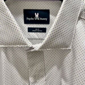 Psycho Bunny slim fit stretch no iron shirt. White background with purple